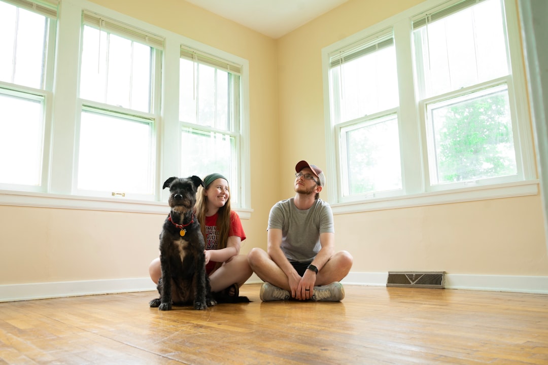 A cozy living room with dog supplies like a bed, toys, and food bowls, ready for a new dog.